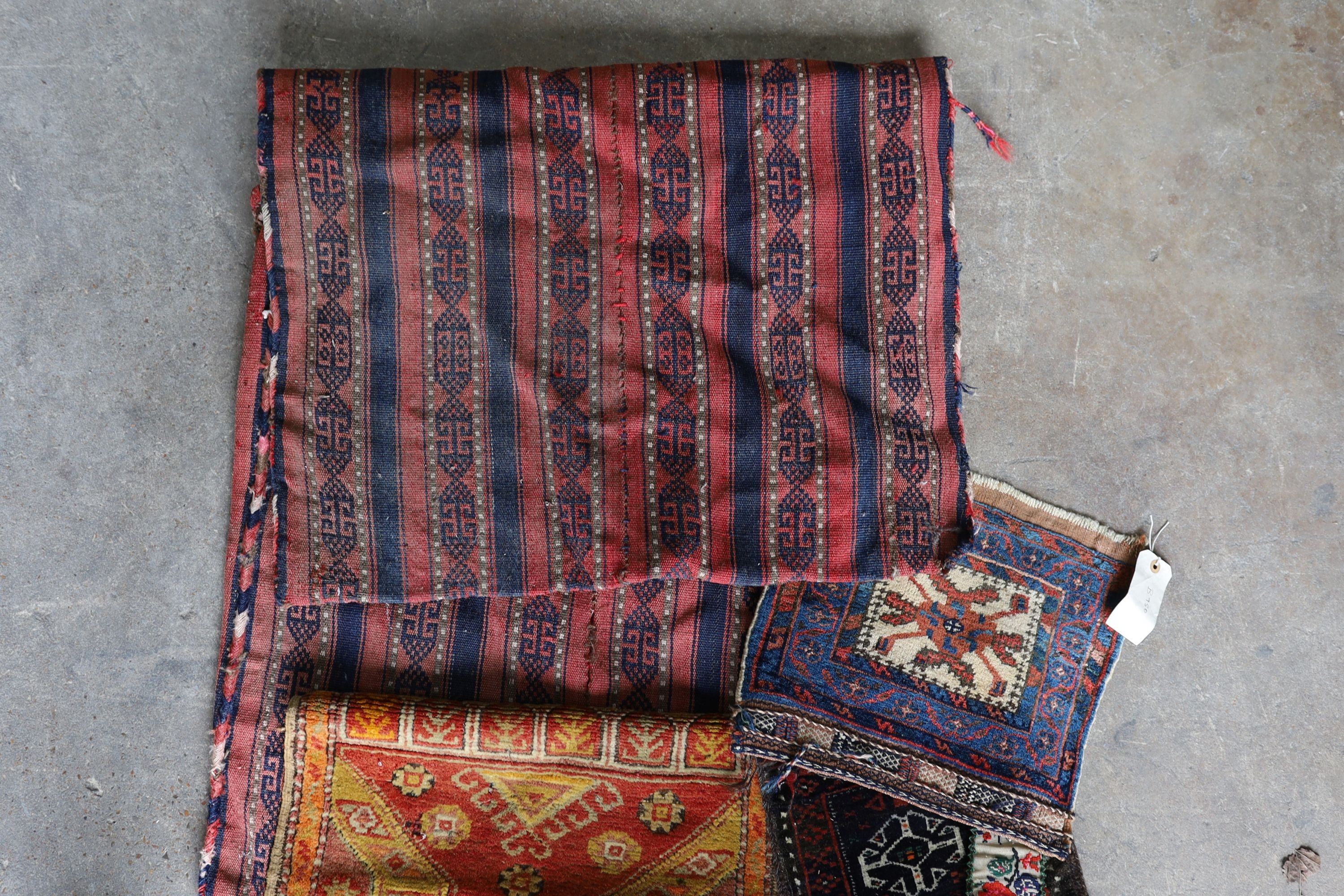 An Afghan Kilim flatweave saddlebag, 144 x 69cm together with six assorted bags, faces, etc.